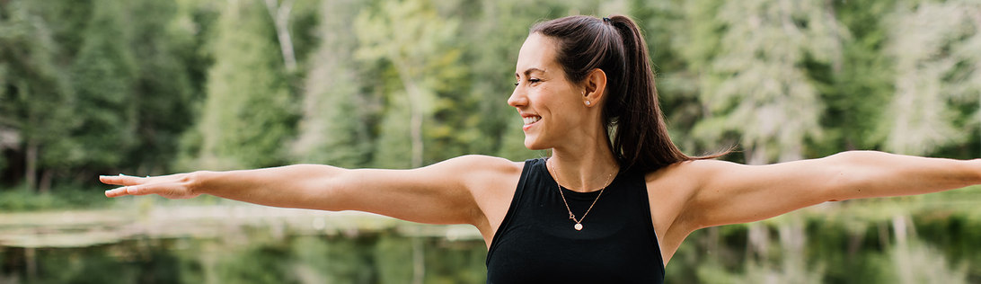 Pilates on Demand online Yoga session. Woman in Warrior 2 position.