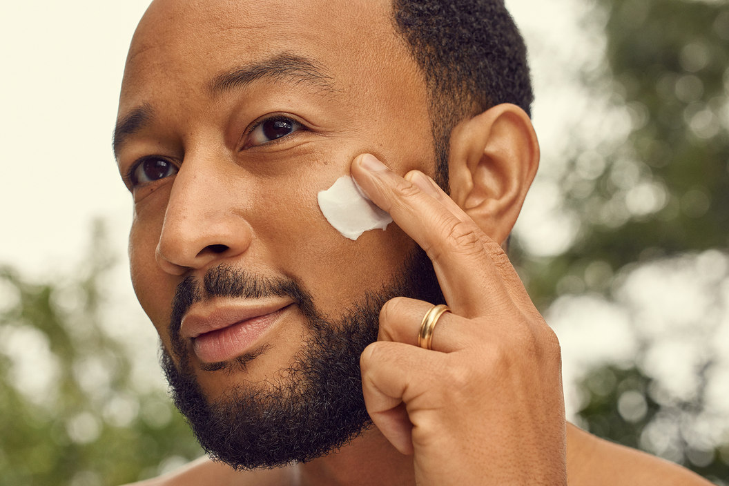 Close up portrait of John Legend putting on face cream by Loved01 Skin. Shot by Chris Gonzales, LA based photograher.