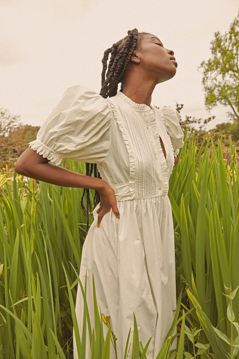Model Miracle S standing in a field in a beautiful dress. Campaign for Doen shot by Chris Gonzales a Los Angeles based fashion and lifestyle photographer.